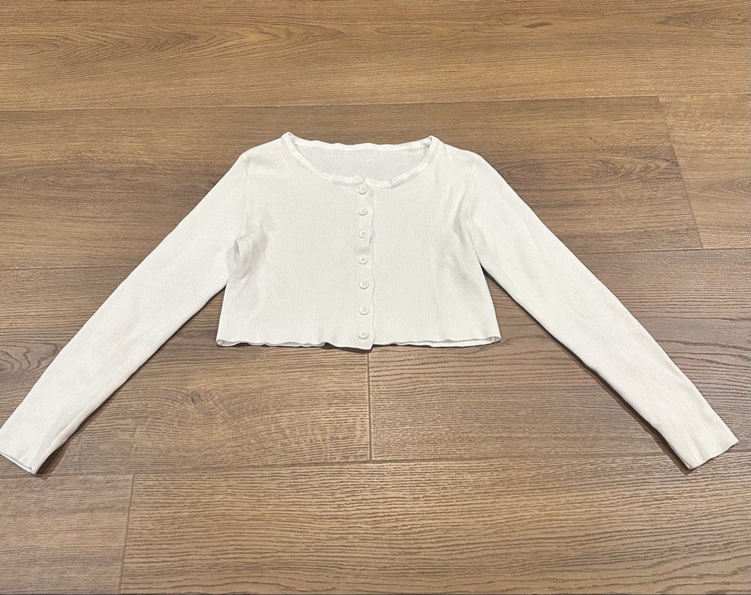 White Cropped Ribbed Cardigan (Category: Coats, Jackets and Outerwear) located in San Juan City. Submitted by yanna_888 (Listing ID 1458963034, Image 1). Description: - White long-sleeved cropped cardigan - Ribbed fabric - Button-up front - Lettuce hem detail - Versatile for layering over tops or dresses.
