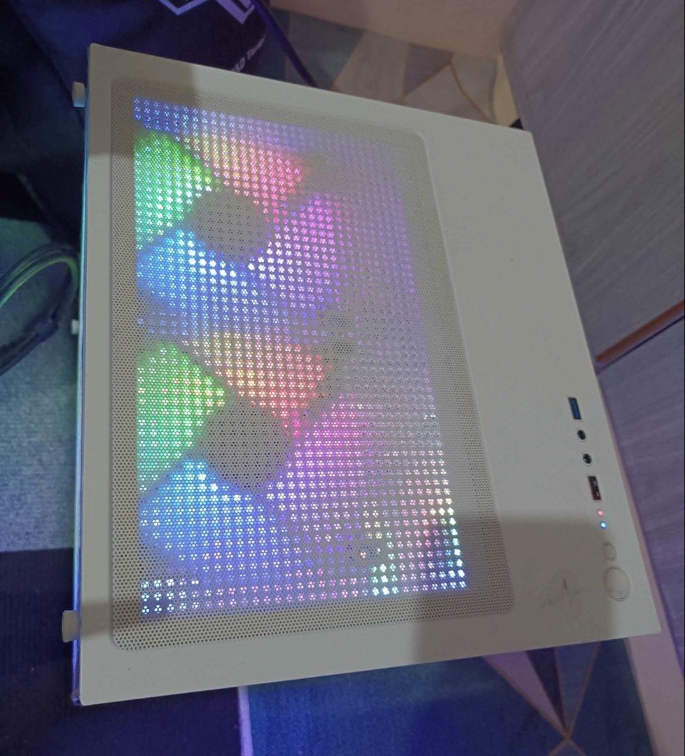 White MATX CASE with RGB Fans (Category: Desktops) located in Camiling. Submitted by notroobbss (Listing ID 1459084303, Image 2). Description: - White ATX PC Case - Multiple RGB Fans for cooling and aesthetics - Tempered Glass Side Panel to showcase your components - RGB Lighting on top panel mesh - Ideal for a gaming PC setup - Ready to install your motherboard, GPU, and other parts.