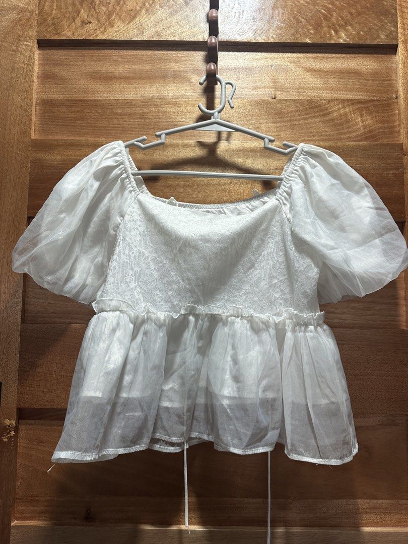 White Puff Sleeve Square Neck Peplum Top (Category: Blouses) located in Quezon City. Submitted by jareddeuna (Listing ID 1458982070, Image 1). Description: - Adorable white top with charming puff sleeves - Elegant square neckline - Delicate lace detailing on the bodice - Flattering peplum hemline - Adjustable drawstrings at the bottom for a customized fit - Perfect for dressing up or down, pairs easily with skirts and pants.