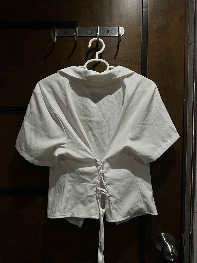 White Short Sleeve Button Up Shirt with Tie Back (Category: Shirts) located in Las Pinas. Submitted by francesaly (Listing ID 1459038423, Image 2). Description: - Classic white short sleeve shirt - Button-up front with a collar - Trendy tie-back detail - Flattering cropped fit - Ideal for casual wear or dressing up - Effortlessly easy to style.
