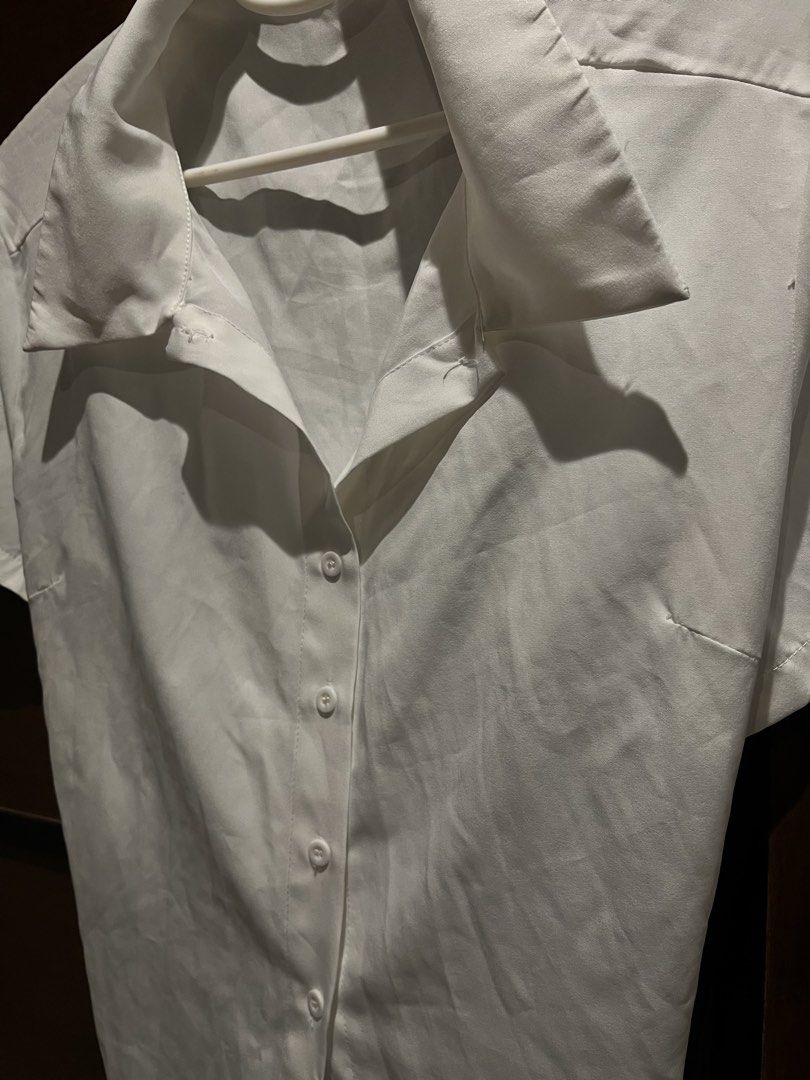 White Short Sleeve Button Up Shirt with Tie Back (Category: Shirts) located in Las Pinas. Submitted by francesaly (Listing ID 1459038423, Image 3). Description: - Classic white short sleeve shirt - Button-up front with a collar - Trendy tie-back detail - Flattering cropped fit - Ideal for casual wear or dressing up - Effortlessly easy to style.