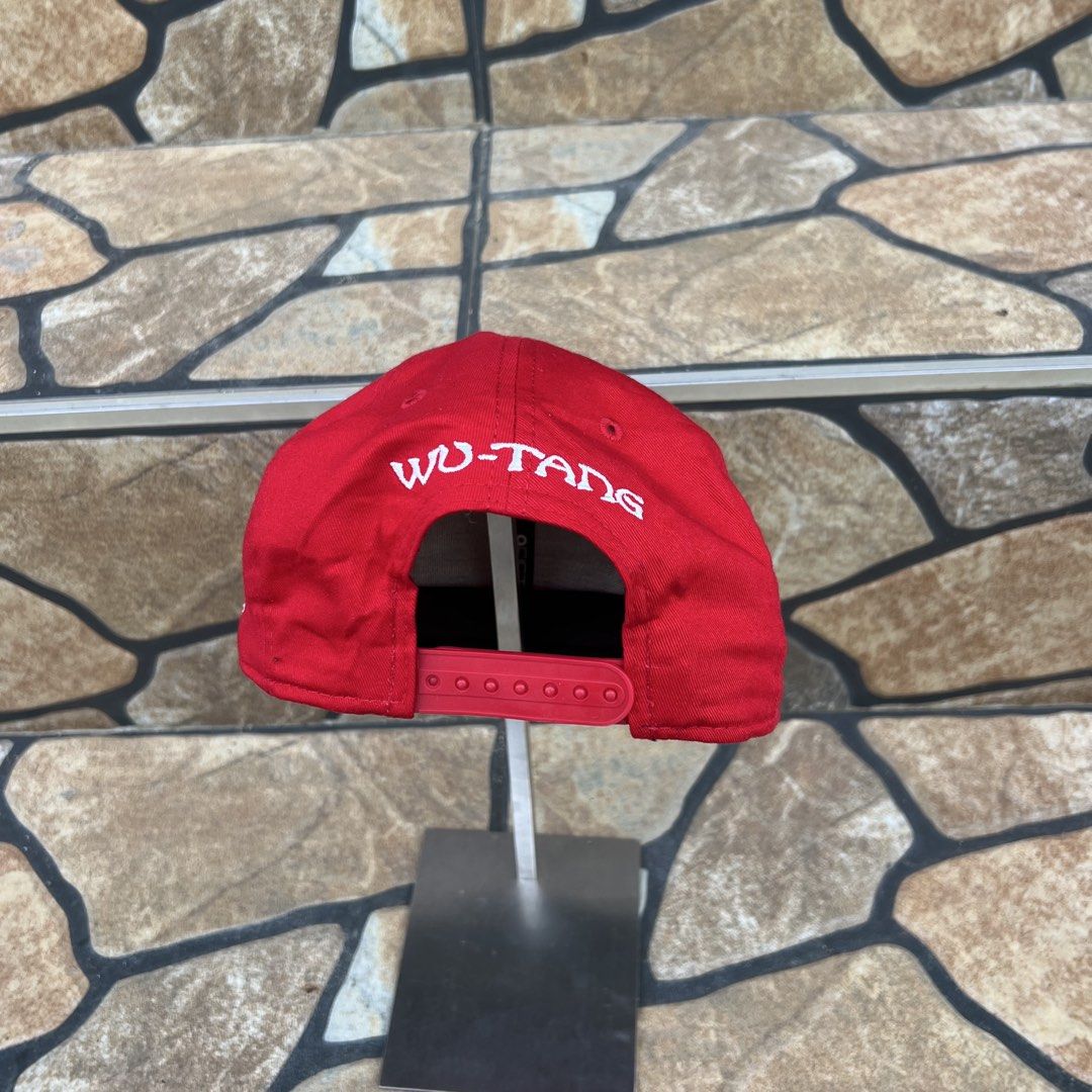 Wu-Tang Clan x New Era Snapback Cap (Category: Caps & Hats) located in Bago City. Submitted by g___shop (Listing ID 1458974484, Image 3). Description: - Authentic Wu-Tang Clan snapback cap. - Features an American flag patch with the iconic Wu-Tang logo on the front. - Stylish camouflage brim underneath. - 'WU-TANG' text embroidered on the back for added flair. - Classic New Era branding on the side. - Adjustable snap closure for a comfortable, cu
