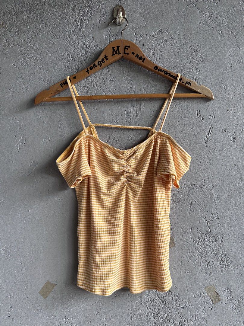 Yellow Gingham Cold Shoulder Ruched Crop Top (Category: Blouses) located in Binan City. Submitted by forgetmenot_ph (Listing ID 1458996656, Image 1). Description: - Cute yellow and white gingham pattern - Ruched front detail - Cold shoulder sleeves - Thin spaghetti straps - Ribbed fabric texture - Pairs well with high-waisted jeans or shorts - Ideal for casual outings and summer vibes.