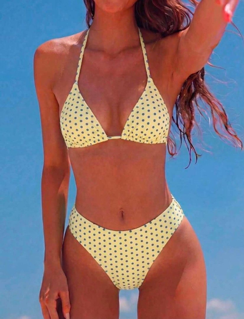 Yellow Polka Dot Triangle Bikini Set (Category: Bikinis & Swimsuits) located in Paranaque City. Submitted by lizzyscloset01 (Listing ID 1458939795, Image 1). Description: - Adorable yellow bikini with a chic grey polka dot pattern. - Features a classic triangle top with adjustable halterneck ties. - Comes with matching high-waisted bottoms for a flattering fit. - Ideal for your next beach getaway or poolside fun. - Combines comfort and style for 