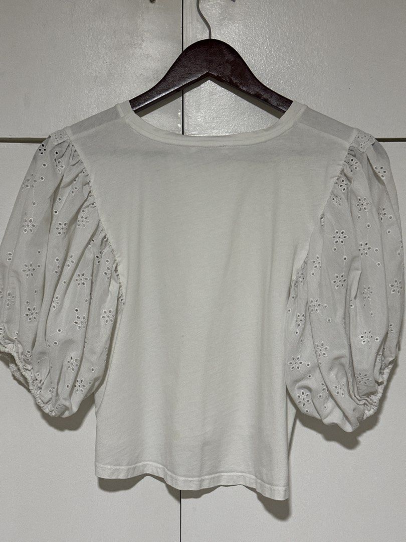 Zara White Eyelet Puff Sleeve Top Size S (Category: Blouses) located in Pasig City. Submitted by tinqsalazar (Listing ID 1458925541, Image 3). Description: - White Zara top - Puff sleeves with eyelet embroidery detail - Short sleeves with elasticated cuffs - Crew neck - Cropped fit - Versatile for casual or dressed-up occasions.