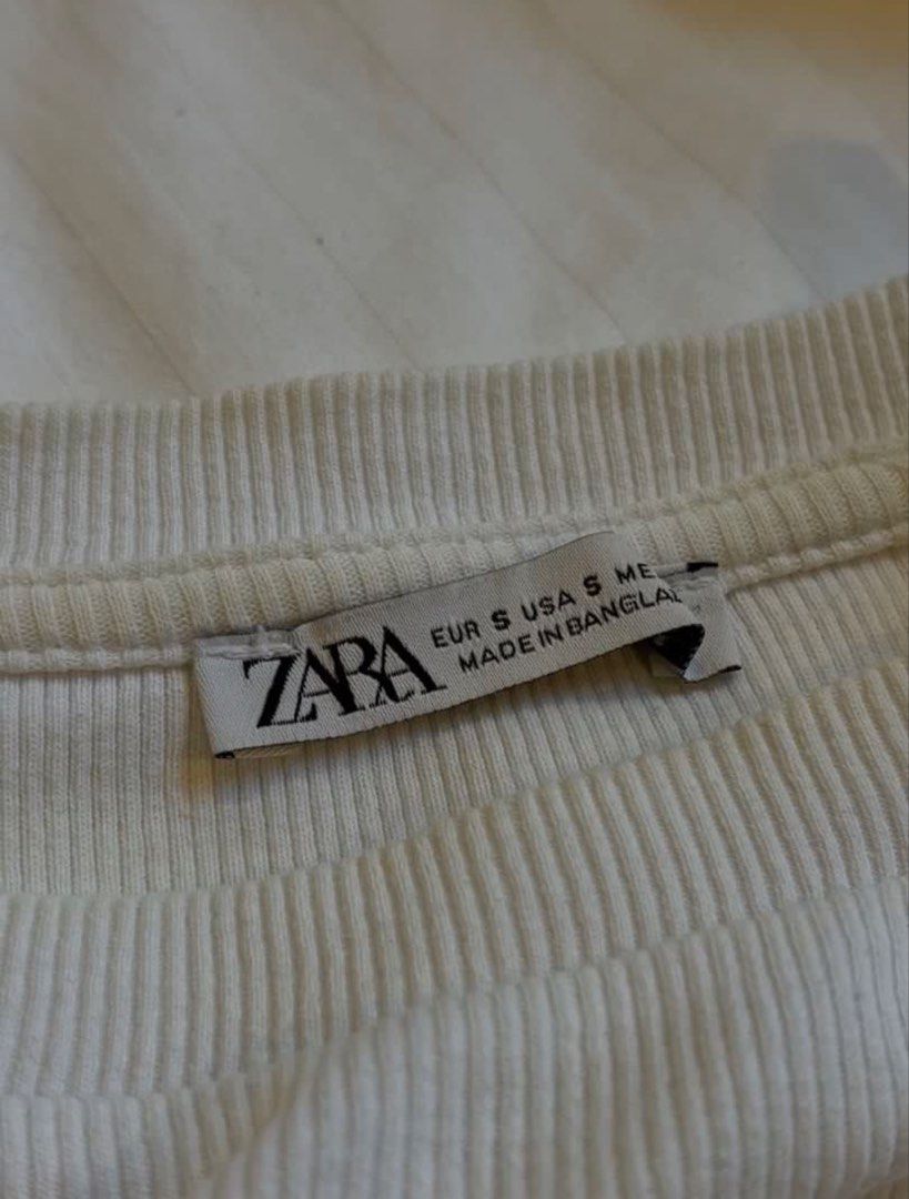 Zara White Top with Flutter Sleeves (Category: Sleeveless) located in Caloocan City. Submitted by lovedby_chi8 (Listing ID 1458914498, Image 2). Description: - Ribbed Stretchy Fabric - Layered flutter sleeves - Soft and comfortable fit - Minimal chic style.