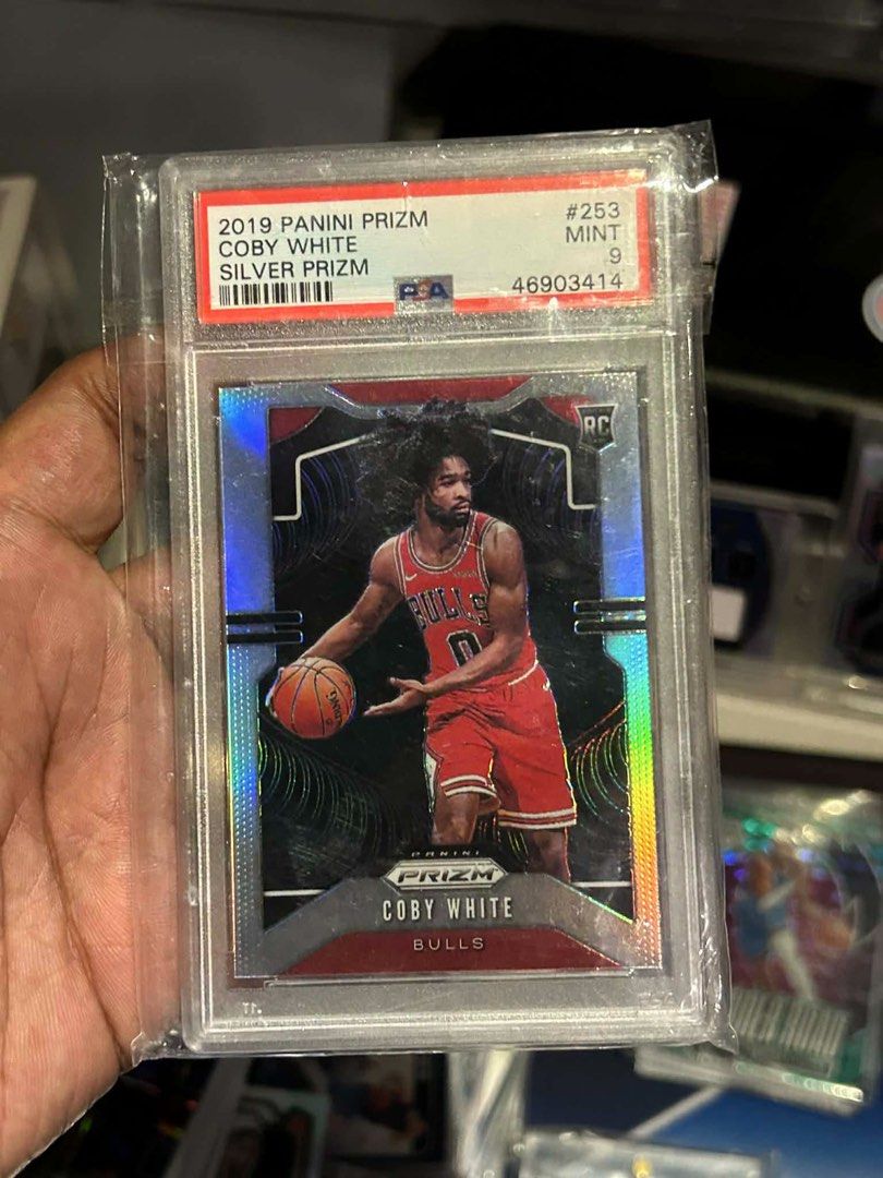 2019 Panini Prizm Coby White Silver Prizm RC PSA 9 (Category: Graded Singles) located in Iloilo. Submitted by jackpot.treasures (Listing ID 1460728419, Image 1). Description: - 2019 Panini Prizm Coby White Rookie Card - Silver Prizm variation - Graded PSA 9 Mint - Card Number: 253 - Ideal for Chicago Bulls fans and Coby White collectors - Don't miss this great addition to your collection!.