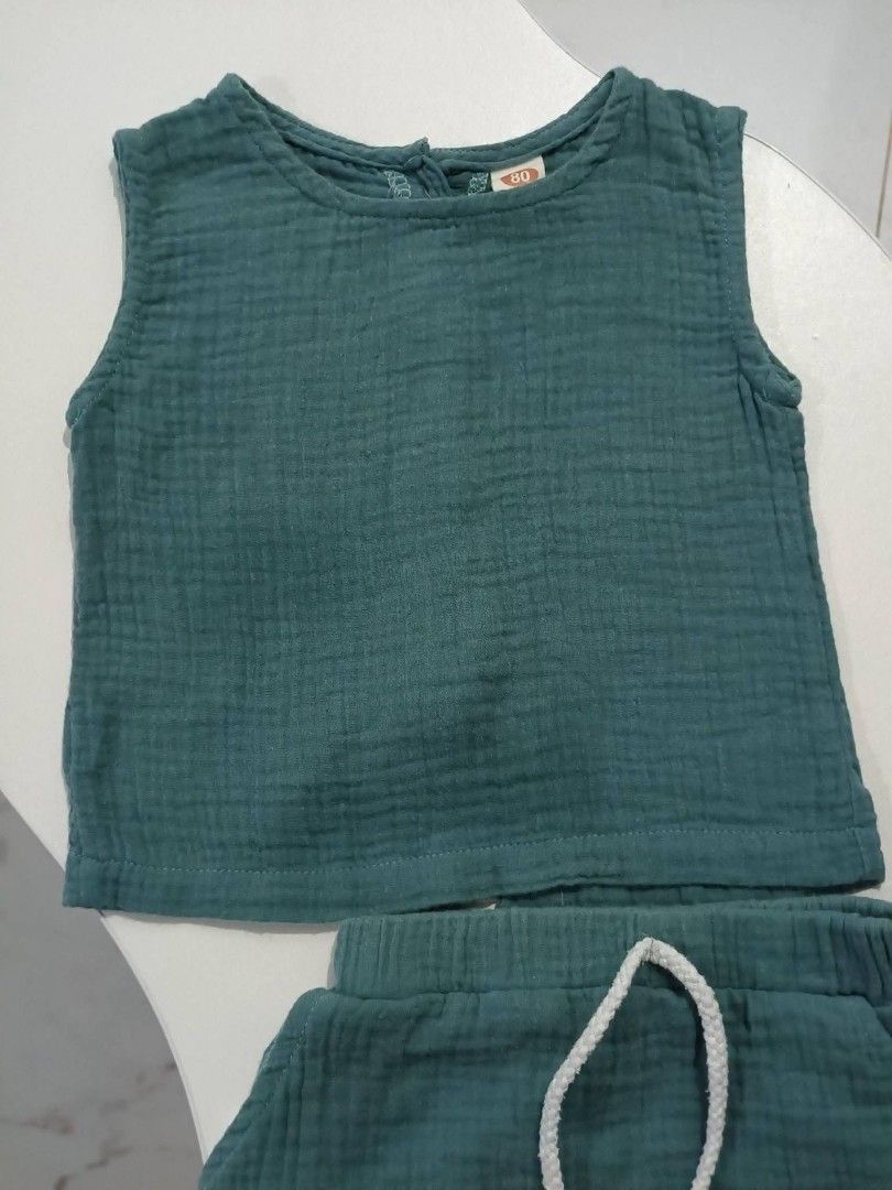 2 PIECE SET INFANT WEAR (Category: Babies & Kids Fashion) located in Baguio. Submitted by ellromavariety (Listing ID 1460904779, Image 3). Description: 2 PIECE SUMMER OUTFIT Size on tag: 80 (9-12 estimate) Set made from lightweight, breathable crinkled muslin cotton gauze.The set includes a sleeveless tank top paired with matching pull-on elastic waistband shorts featuring a thick white cotton rope drawstring..