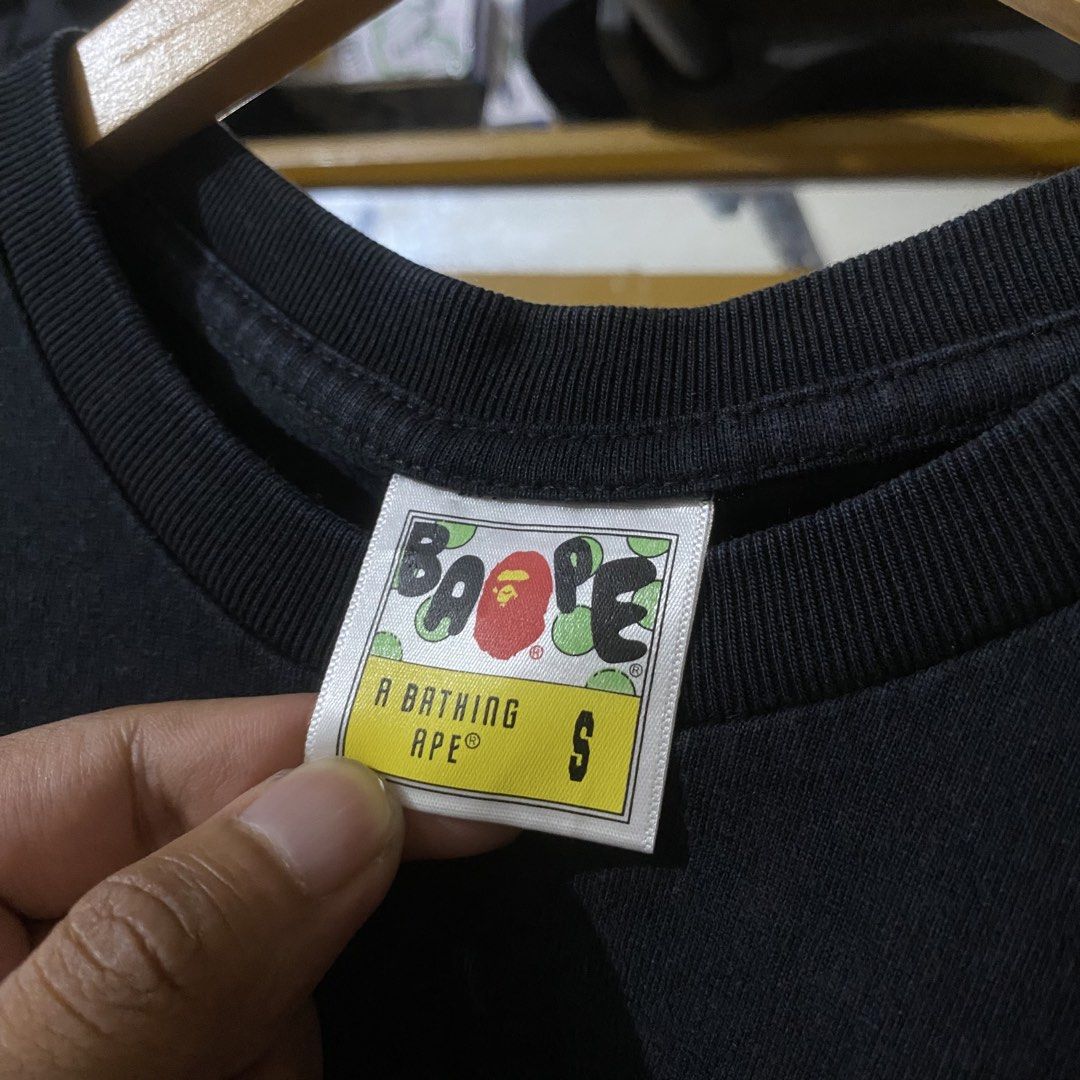 A Bathing Ape BAPE College Logo Shirt (Category: Tshirts & Polo Shirts ) located in Manila. Submitted by 4114thrifts.ph (Listing ID 1460875489, Image 3). Description: Item Name: A Bathing Ape BAPE College Logo Shirt (Details) • Size: Small on tag • Dimes: 20x26 • Color Rate: 9.4/10 • Issue/s: Need Wash Only Mine: 1,050 Free Shipping 📥 Dasmariñas City, Cavite, 4114📍.