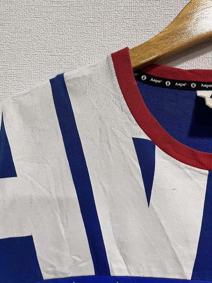 Aape (Category: Tshirts & Polo Shirts ) located in Roxas City. Submitted by cheat_thrifts (Listing ID 1460907897, Image 3). Description: Brand: ✅ AAPE by A Bathing Ape — Colorway: Bold red, white, & royal blue — patriotic streetwear palette Fit: Relaxed / regular cut — crew neck with red ribbed trim, short sleeves .