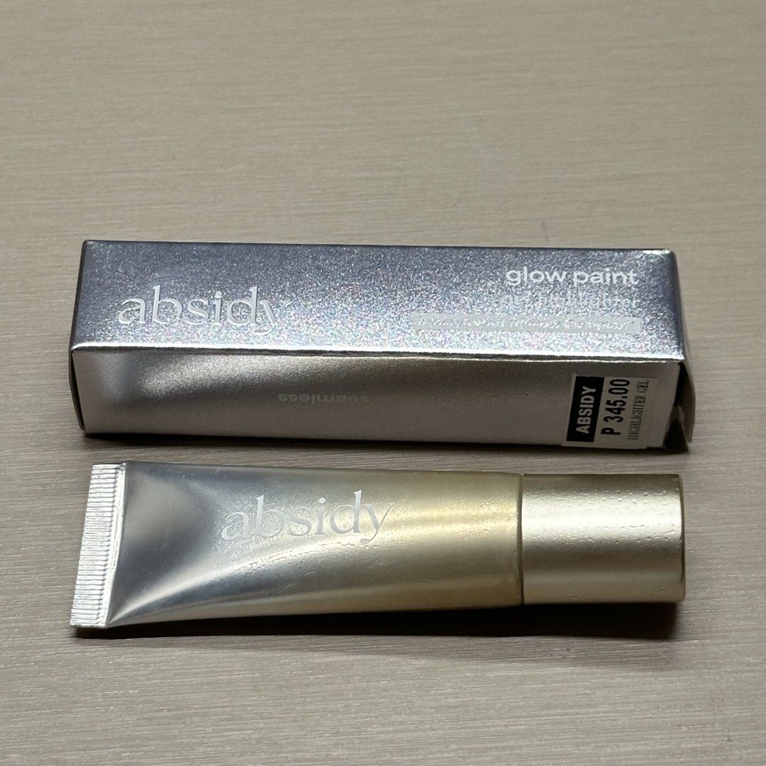 Absidy Glow Paint Highlighter - Halo (Category: Makeup) located in Manila. Submitted by luxeauthentics (Listing ID 1460832903, Image 2). Description: Used twice only and full Purchased July 2026 - Product: Absidy Glow Paint - Shade: Halo - Type: Highlighter Gel - Condition: Brand new, in original packaging - Features: Adds a radiant glow - Packaging: Includes branded box with text and expiry date, and branded tube.