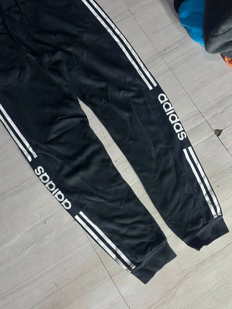 Adidas Black Track Pants with White Stripes (Category: Joggers) located in Manila. Submitted by nb_thriftshop (Listing ID 1460895980, Image 2). Description: adi jogger pants waist 27 to 30 has lace and garter length 37 leg hole 11 no issue like new.