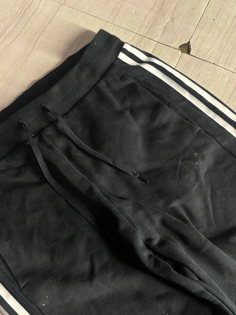 Adidas Black Track Pants with White Stripes (Category: Joggers) located in Manila. Submitted by nb_thriftshop (Listing ID 1460895980, Image 3). Description: adi jogger pants waist 27 to 30 has lace and garter length 37 leg hole 11 no issue like new.
