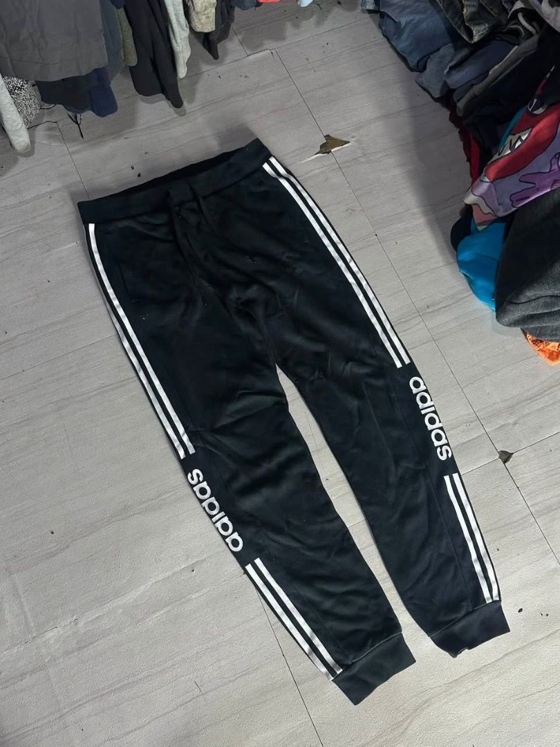 Adidas Black Track Pants with White Stripes (Category: Joggers) located in Manila. Submitted by nb_thriftshop (Listing ID 1460895980, Image 1). Description: adi jogger pants waist 27 to 30 has lace and garter length 37 leg hole 11 no issue like new.
