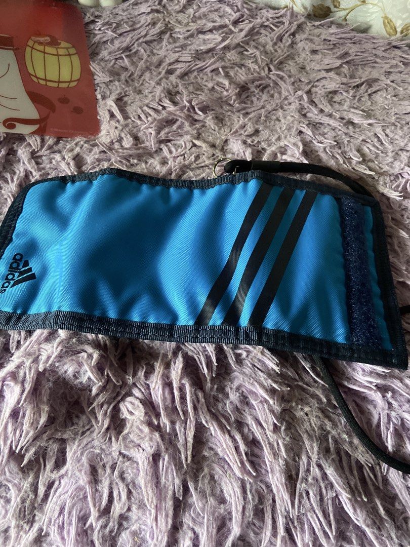 Adidas Blue Wallet with Lanyard (Category: Wallets & Card holders) located in Davao. Submitted by mengsmixitems (Listing ID 1460786601, Image 2). Description: - Blue Adidas wallet with classic black stripes. - Multiple card slots for all your cards. - Convenient coin pouch inside. - Includes a detachable black lanyard strap. - Perfect for organizing essentials for everyday or travel..
