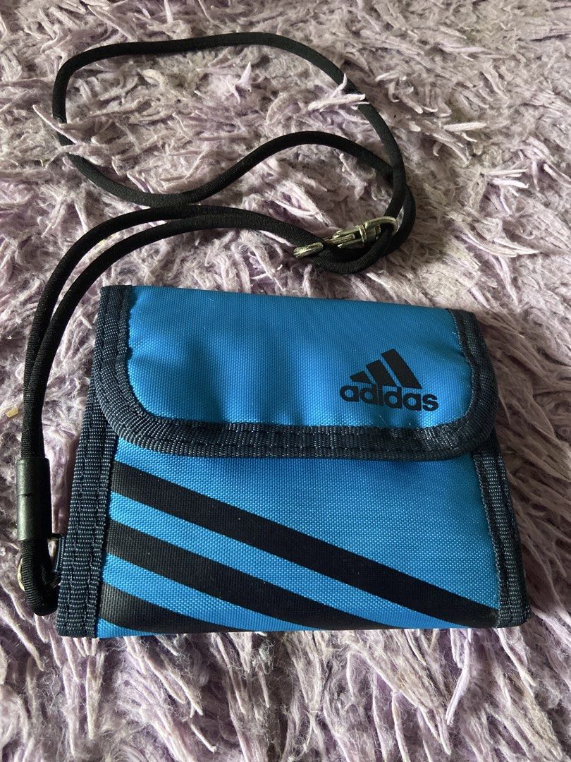 Adidas Blue Wallet with Lanyard (Category: Wallets & Card holders) located in Davao. Submitted by mengsmixitems (Listing ID 1460786601, Image 1). Description: - Blue Adidas wallet with classic black stripes. - Multiple card slots for all your cards. - Convenient coin pouch inside. - Includes a detachable black lanyard strap. - Perfect for organizing essentials for everyday or travel..