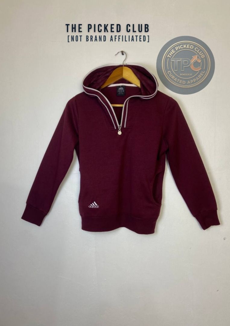 Adidas Burgundy Half Zip Hoodie (Category: Coats, Jackets and Outerwear) located in Imus. Submitted by thepickedclub (Listing ID 1460763538, Image 1). Description: large (20x22) - Burgundy Adidas hoodie - Half zip closure - Kangaroo pocket for essentials - White trim detail on hood and zipper - Small Adidas logo on the chest - Ideal for everyday casual wear.