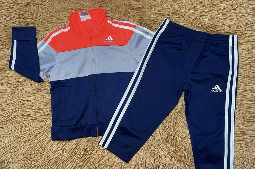 Adidas Colorblock Tracksuit Jacket and Pants Set (Category: Babies & Kids Fashion) located in Manila. Submitted by kyongg0122 (Listing ID 1460895569, Image 1). Description: - Adidas tracksuit set - Jacket: Coral, grey, and navy colorblocking with white sleeve stripes - Pants: Matching navy with white side stripes - Jacket features: Full zip, stand-up collar - Pants feature: Elastic waistband - Ideal for sports or casual wear.