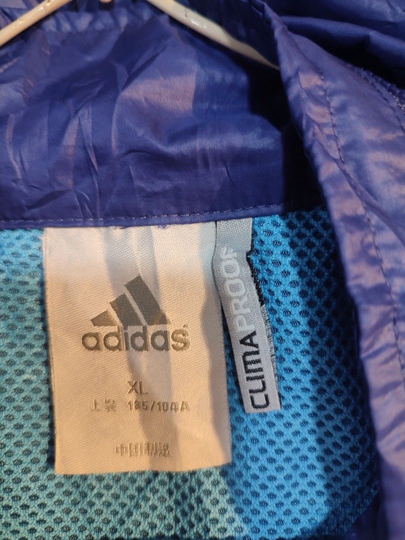 Adidas Lightweight Hooded Windbreaker Jacket Blue (Category: Coats, Jackets and Outerwear) located in Manila. Submitted by momofunodos (Listing ID 1460831697, Image 2). Description: - Blue Adidas windbreaker jacket - Features a hood - Full zip front closure - Two side pockets - Lightweight and packable design - Ideal for outdoor activities - Contrasting light blue zipper and hood lining - Adidas logo prominently displayed on the chest Note! buy a