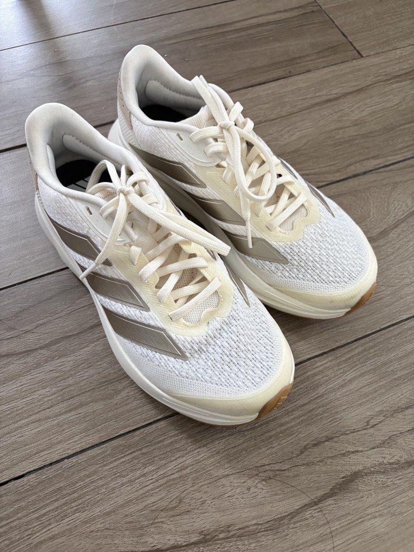 Adidas Shoes (Category: Sneakers) located in Quezon City. Submitted by misserika (Listing ID 1460722018, Image 1). Description: - White and gold Adidas running shoes - Lightweight mesh - No longer comes with box - Used once RFS: Bought the wrong size, too big.