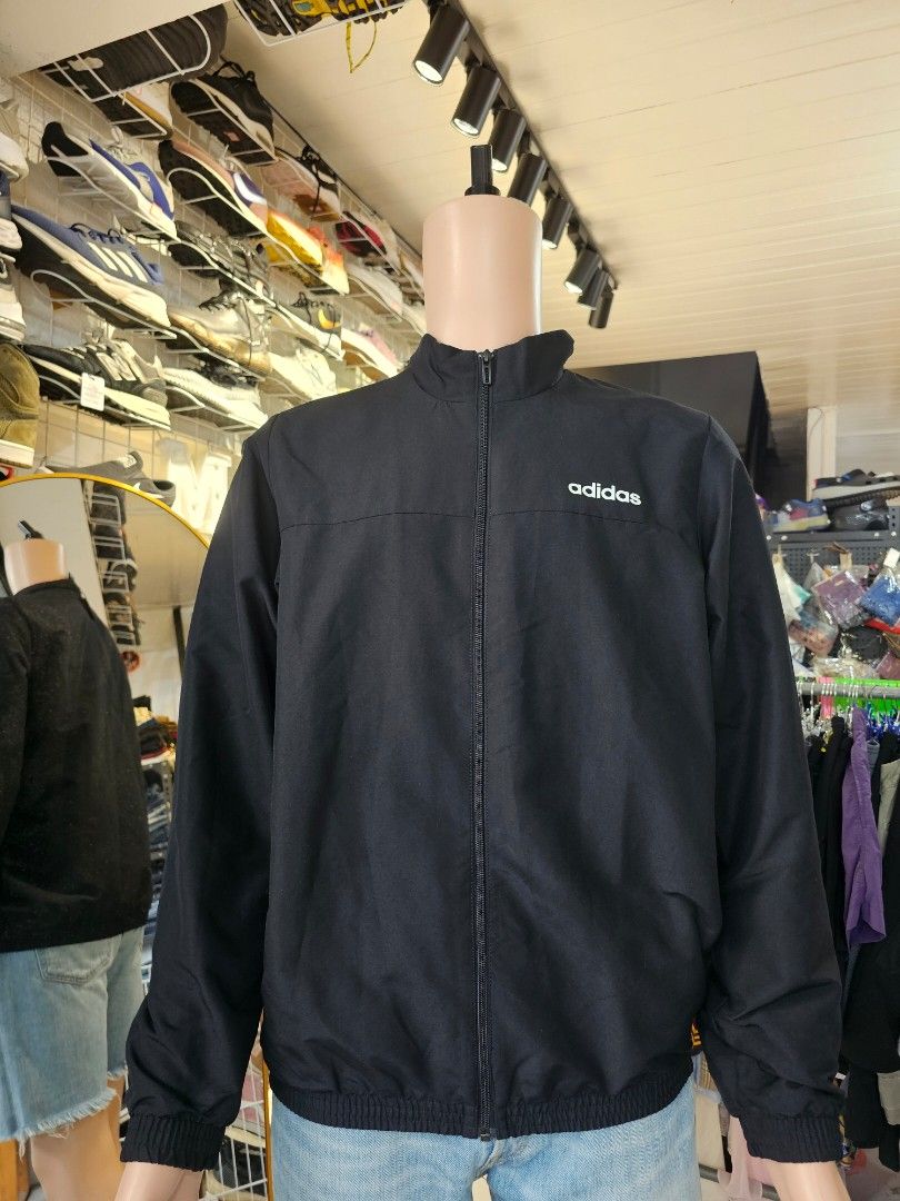 Adidas full zip track jacket (Category: Coats, Jackets and Outerwear) located in Baguio. Submitted by kayeonlineshop (Listing ID 1460801648, Image 2). Description: -black Adidas track jacket featuring a stand-up collar and a white brand logo on the chest -measurements included in the photos.