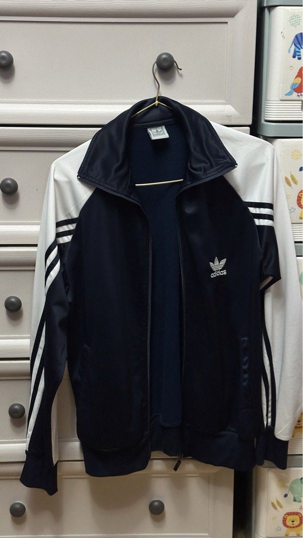 Adidas Track Jacket Navy White (Category: Coats, Jackets and Outerwear) located in Antipolo. Submitted by Jhedqt. (Listing ID 1460870402, Image 1). Description: - Classic Adidas track jacket - Navy blue body with white sleeves - Iconic three stripes on sleeves - Full zip front closure - Adidas trefoil logo on chest - Ideal for casual wear or sports activities S-M.