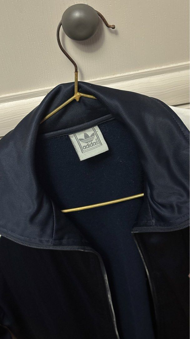 Adidas Track Jacket Navy White (Category: Coats, Jackets and Outerwear) located in Antipolo. Submitted by Jhedqt. (Listing ID 1460870402, Image 2). Description: - Classic Adidas track jacket - Navy blue body with white sleeves - Iconic three stripes on sleeves - Full zip front closure - Adidas trefoil logo on chest - Ideal for casual wear or sports activities S-M.