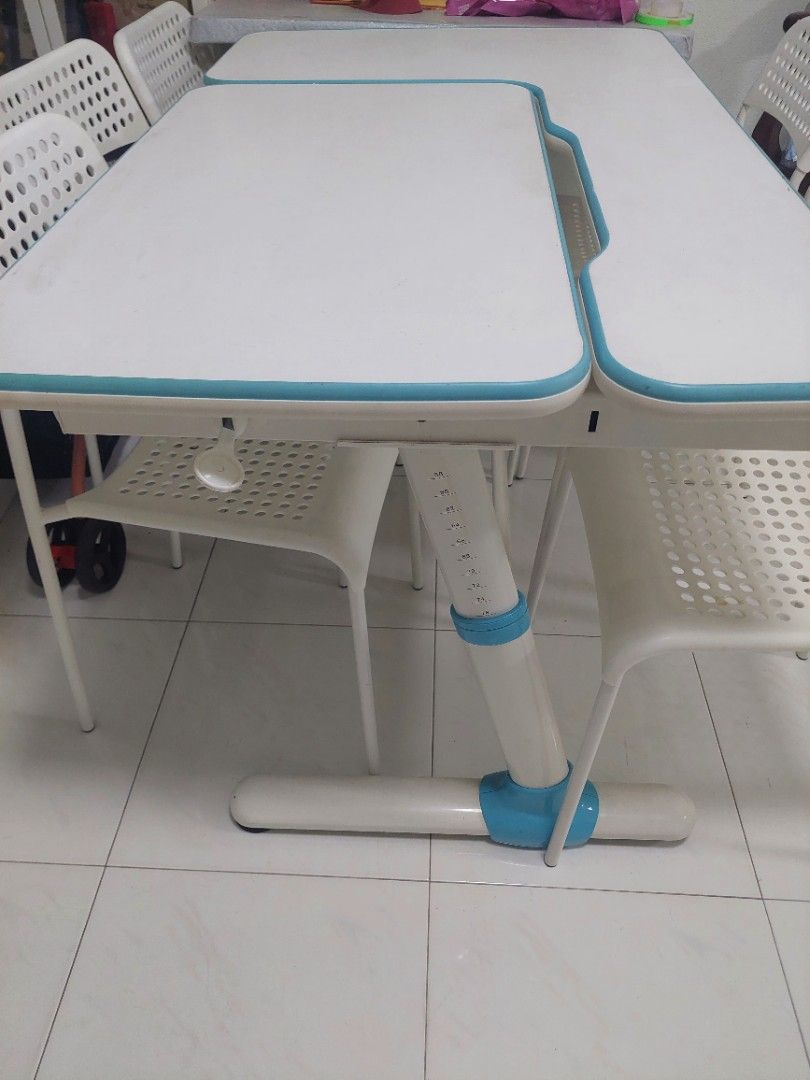 Study Table w Adjustable Height & white Chairs (Category: Tables & Sets) located in Singapore. Submitted by chrisanton (Listing ID 1460783995, Image 3). Description: - White and blue study table - Table features a smooth surface - Adjustable height - Ideal for a room or study - Easy to clean.