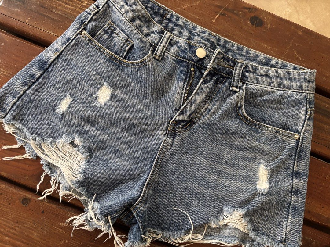 AIMILAN Blue Distressed Denim Shorts Size 29 (Category: Shorts) located in Calamba. Submitted by s3r3s4 (Listing ID 1460749475, Image 1). Description: - Blue denim shorts - Distressed details - Frayed hem - Classic five-pocket style - Zip fly and button closure - Comfortable and stylish for casual wear - Ideal for summer outfits.