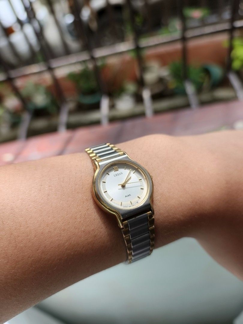 ALBA URBAN (Category: Women's Watches) located in Manila. Submitted by altlazo23 (Listing ID 1460905853, Image 2). Description: - ALBA URBAN Watch - Two-tone stainless steel band - White dial with Roman numeral at 12 o'clock - Water resistant - Base metal bezel - Stainless steel back - Made in Japan - Model: V801-0200 AO - Serial Number: 190024.
