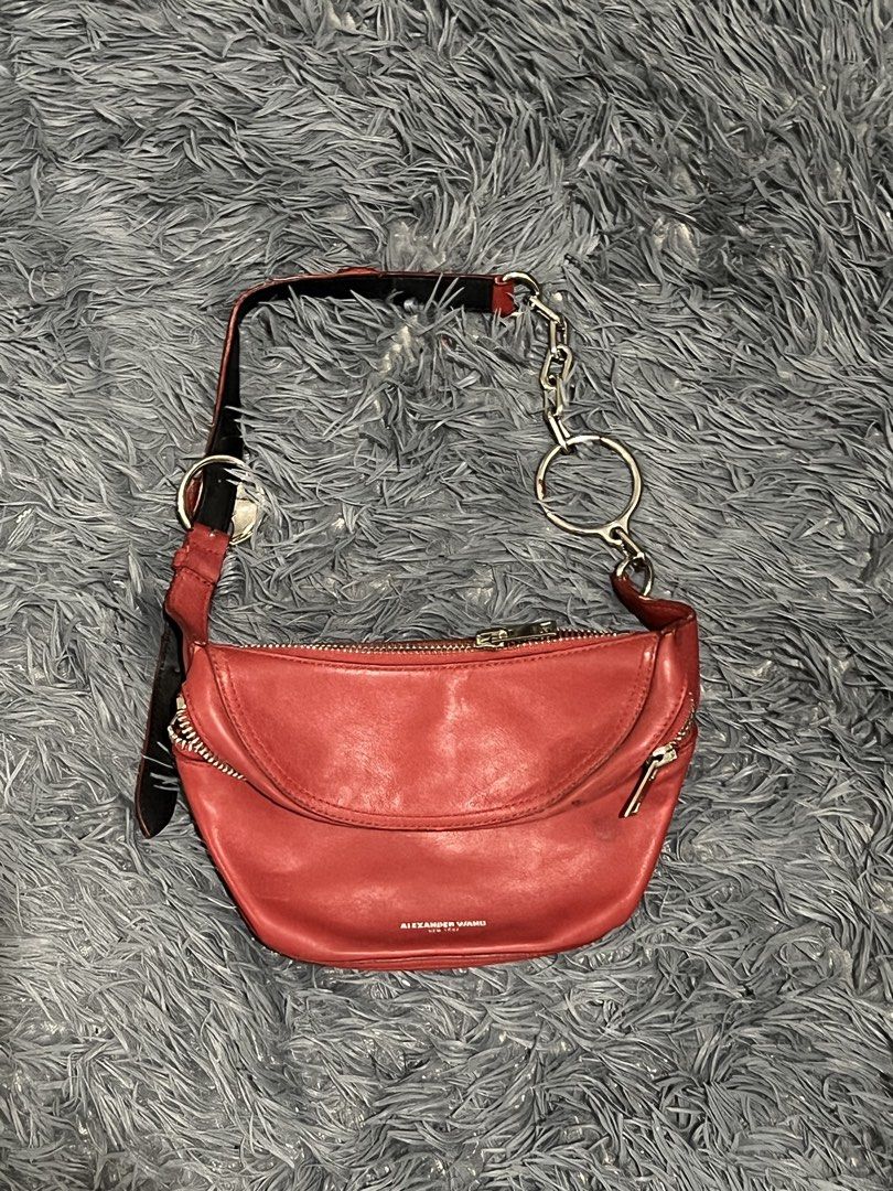 Alexander Wang Leather Belt Bag (Category: Luxury Bags & Wallets) located in Cainta. Submitted by xkengkaix (Listing ID 1460909333, Image 2). Description: - Authentic Alexander Wang red leather belt bag - Stylish curved silhouette - Secure zip closure - Chic chain strap with statement metal rings - Subtle embossed Alexander Wang New York logo on the front - Ideal for everyday wear and adding a pop of color to your outfit.