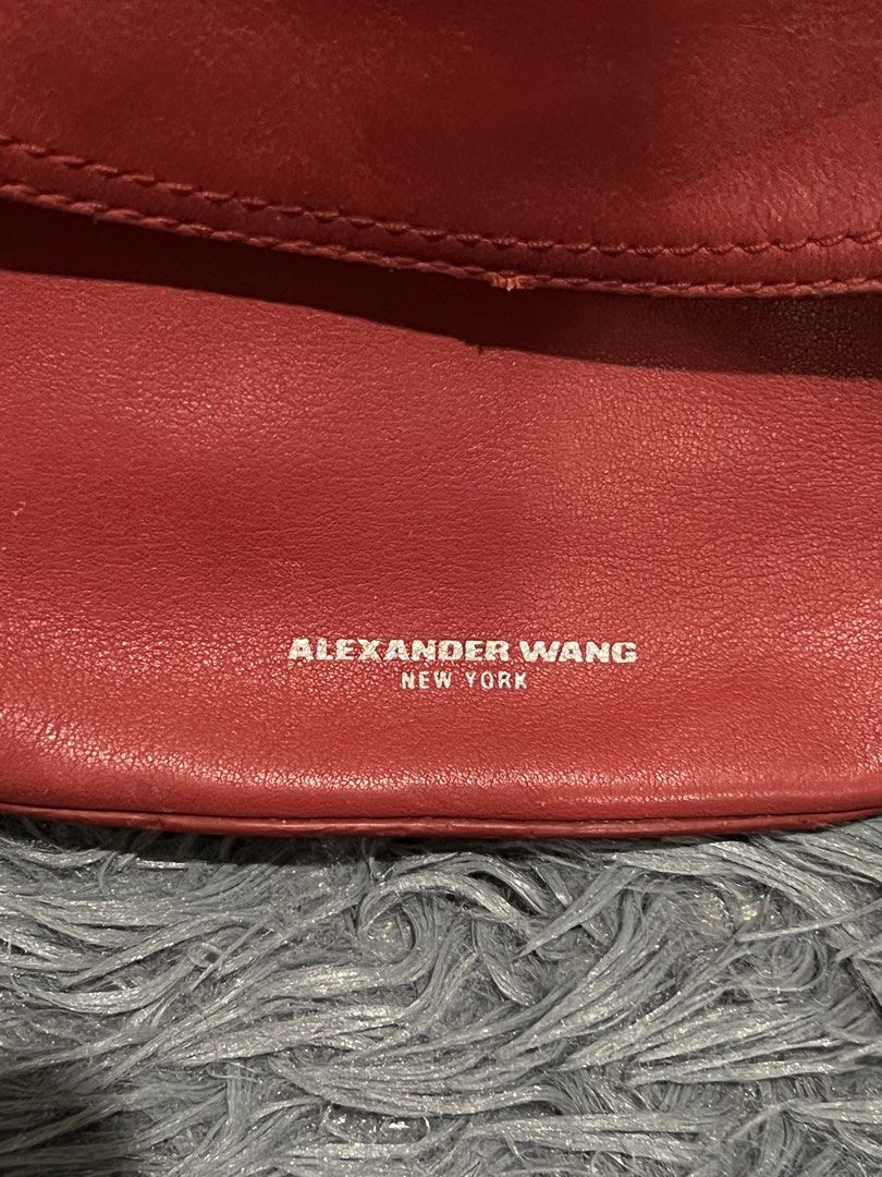 Alexander Wang Leather Belt Bag (Category: Luxury Bags & Wallets) located in Cainta. Submitted by xkengkaix (Listing ID 1460909333, Image 3). Description: - Authentic Alexander Wang red leather belt bag - Stylish curved silhouette - Secure zip closure - Chic chain strap with statement metal rings - Subtle embossed Alexander Wang New York logo on the front - Ideal for everyday wear and adding a pop of color to your outfit.