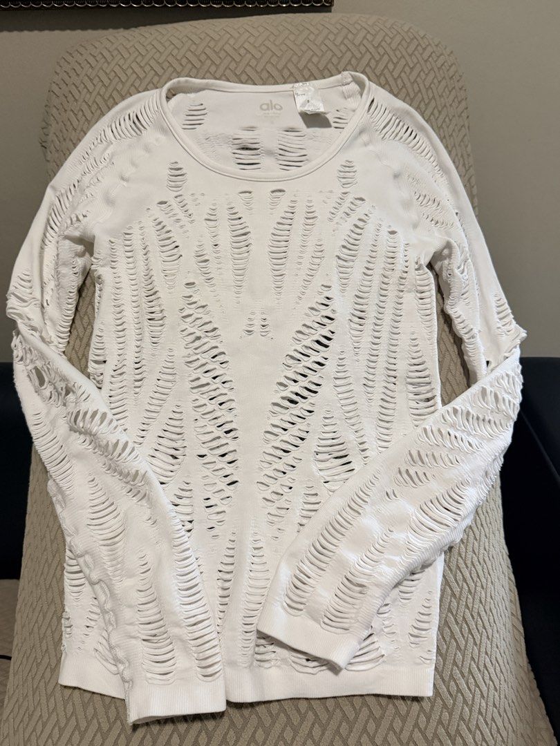 Alo White Distressed Long Sleeve Top Size S (Category: Activewear) located in Caloocan City. Submitted by miutasha888 (Listing ID 1460810547, Image 1). Description: - Brand: Alo - Color: White - Style: Long sleeve top - Design: Distressed, ripped all over - Material: Polyester and Spandex - Size: S - Origin: Made in Turkey - Perfect for layering or as a statement piece.