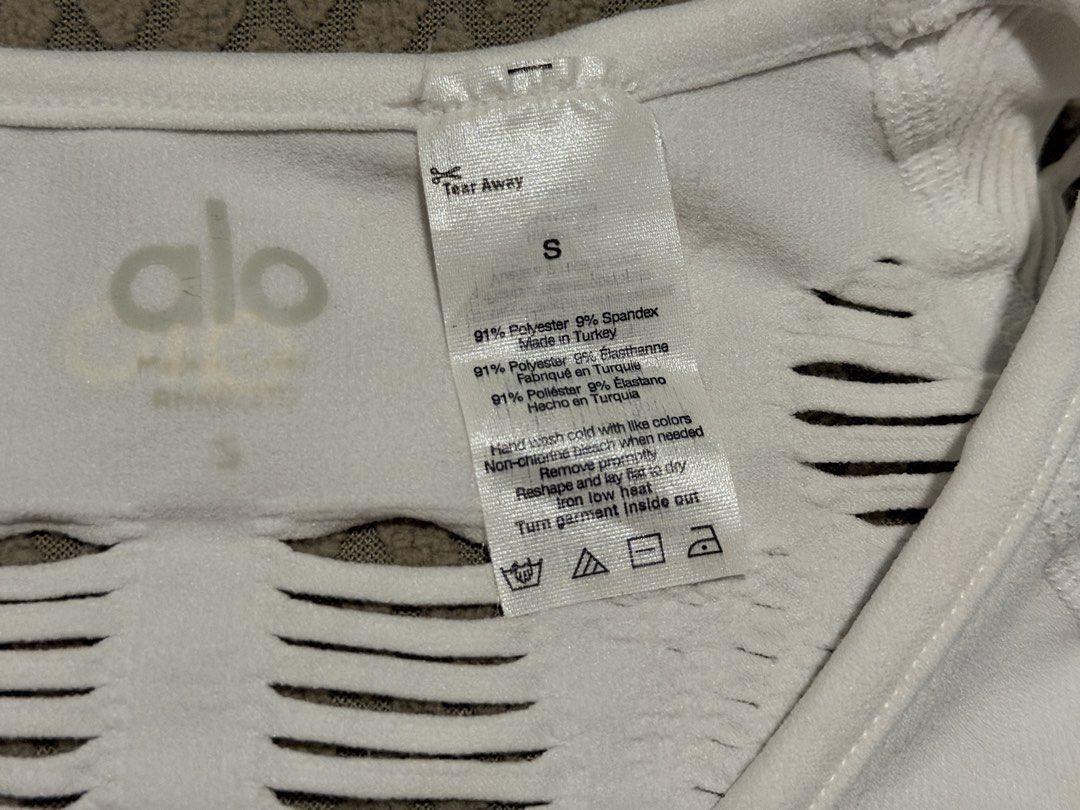 Alo White Distressed Long Sleeve Top Size S (Category: Activewear) located in Caloocan City. Submitted by miutasha888 (Listing ID 1460810547, Image 2). Description: - Brand: Alo - Color: White - Style: Long sleeve top - Design: Distressed, ripped all over - Material: Polyester and Spandex - Size: S - Origin: Made in Turkey - Perfect for layering or as a statement piece.
