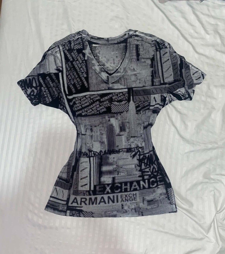 Armani Exchange Black & White V-neck shirt (Category: Shirts) located in Cabuyao City. Submitted by lamperouge11 (Listing ID 1460646310, Image 3). Description: A piece of black & white v-neck shirt from Armani Exchange. Features: - A v neck collar. - Repeating "Armani Exchange" line from the front and back. - Random sign & shapes in color black and white. Flaws: Distressed print. Condition: Great Size: Xs on tag Dimensions: L27×W16.5.