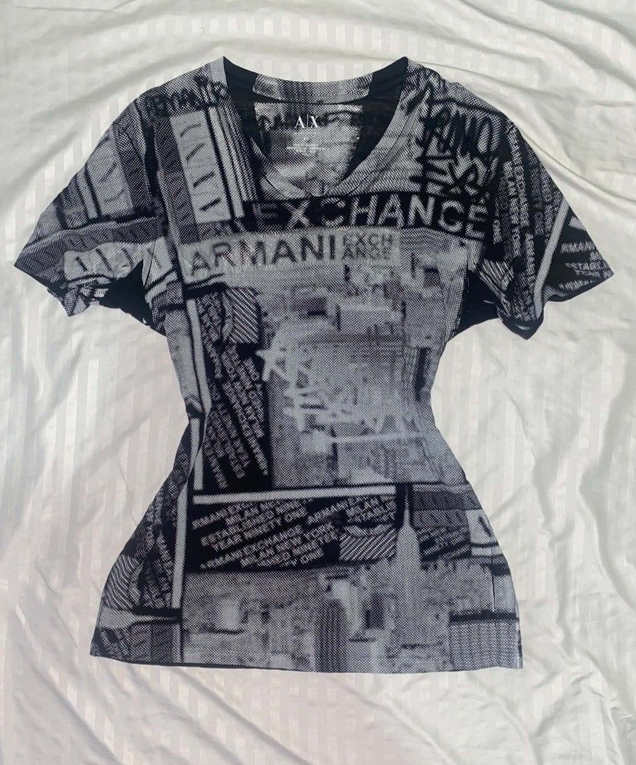 Armani Exchange Black & White V-neck shirt (Category: Shirts) located in Cabuyao City. Submitted by lamperouge11 (Listing ID 1460646310, Image 1). Description: A piece of black & white v-neck shirt from Armani Exchange. Features: - A v neck collar. - Repeating "Armani Exchange" line from the front and back. - Random sign & shapes in color black and white. Flaws: Distressed print. Condition: Great Size: Xs on tag Dimensions: L27×W16.5.