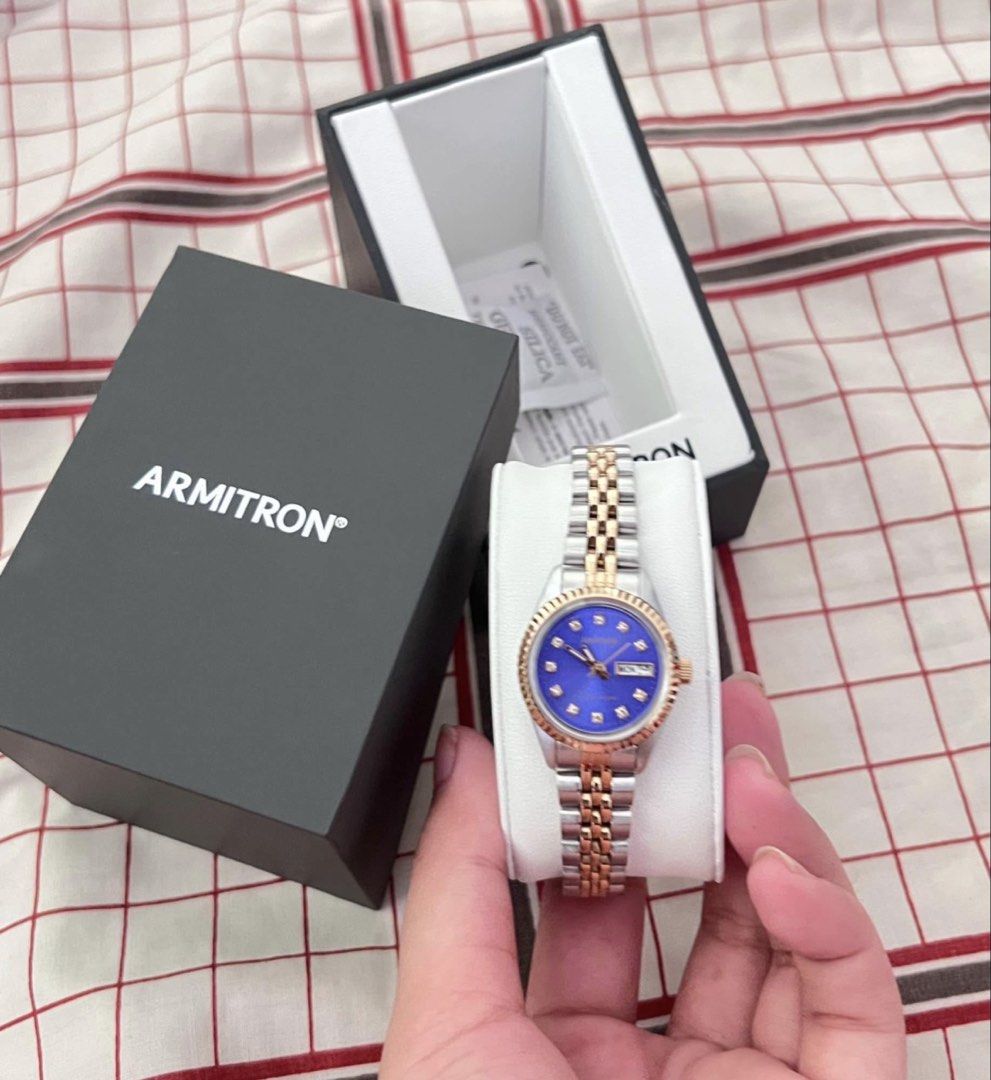 Armitron Two-Tone Blue Dial Day-Date Watch (Category: Women's Watches) located in Manila. Submitted by allysamaligaya28 (Listing ID 1460756602, Image 3). Description: - Armitron Watch - Stunning Blue Dial - Elegant Diamond Markers - Two-Tone Silver and Gold Band - Convenient Day and Date Display - Comes with Original Box , warranty/manual, and Silica Gel Packet - Versatile: Ideal for Everyday or Special Occasions.