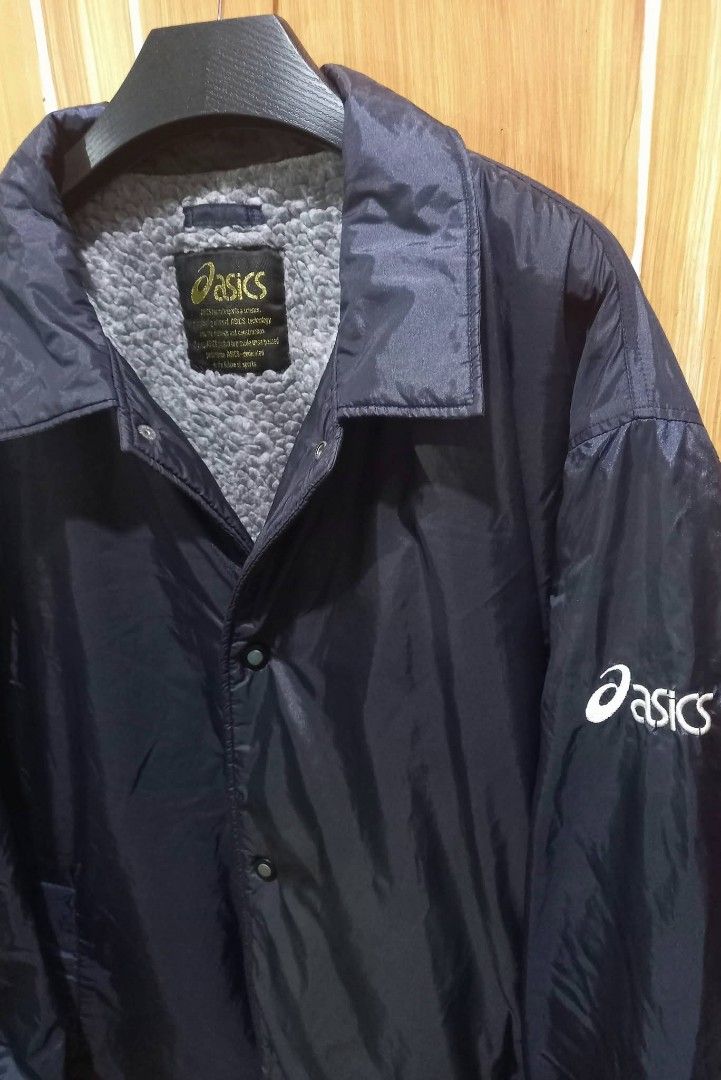 Asics Navy Blue Sherpa Lined Coach Jacket (Category: Coats, Jackets and Outerwear) located in Baguio. Submitted by jiannisthriftfits (Listing ID 1460916755, Image 3). Description: - Navy blue Asics coach jacket - Sherpa lined for extra warmth - Classic Asics logo on chest and sleeve - Button-up front - Ideal for cooler weather - Suitable for casual wear or sports.