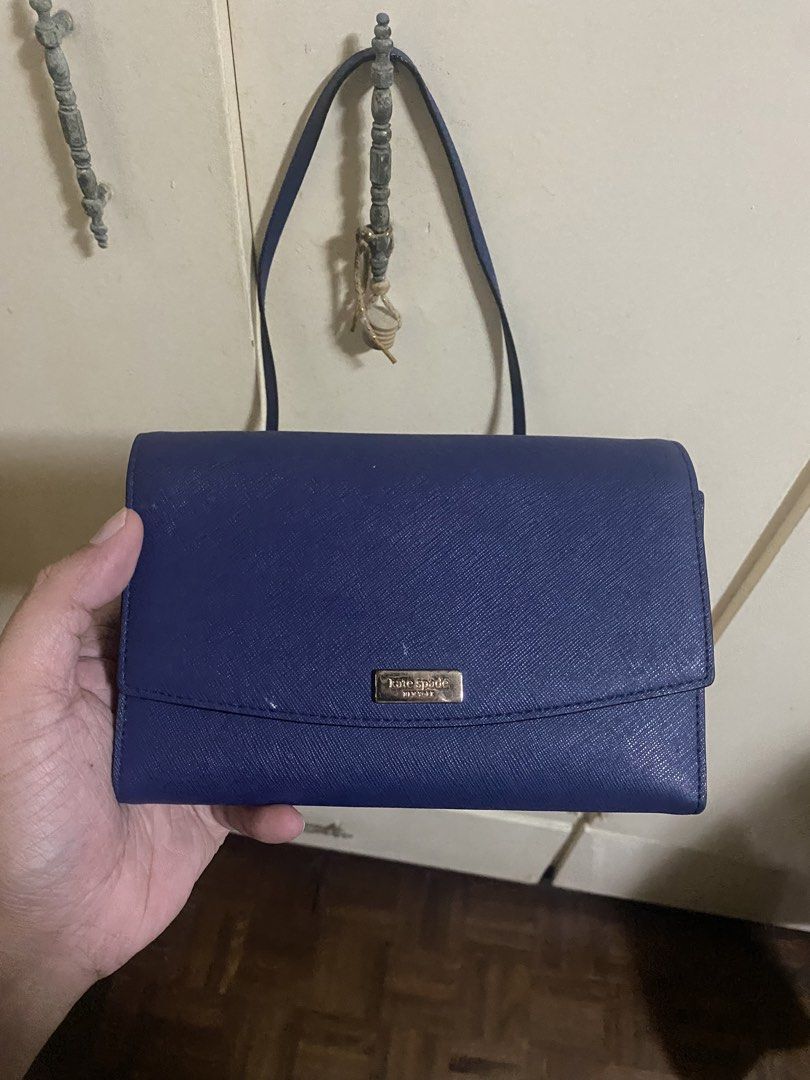 Authentic Kate Spade crossbody wallet (Category: Cross-body Bags) located in Marikina City. Submitted by angelinigo12 (Listing ID 1460877441, Image 1). Description: - Authentic Kate Spade crossbody wallet - Elegant deep blue color - Saffiano leather texture - Multiple card slots for organization - Zippered compartment for coins or small items - Secure snap closure - Available for meetup in Marikina City.