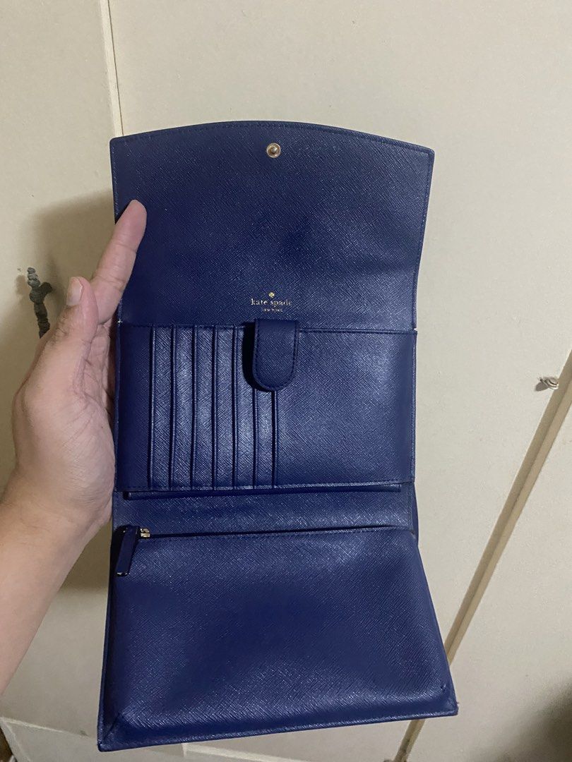 Authentic Kate Spade crossbody wallet (Category: Cross-body Bags) located in Marikina City. Submitted by angelinigo12 (Listing ID 1460877441, Image 3). Description: - Authentic Kate Spade crossbody wallet - Elegant deep blue color - Saffiano leather texture - Multiple card slots for organization - Zippered compartment for coins or small items - Secure snap closure - Available for meetup in Marikina City.