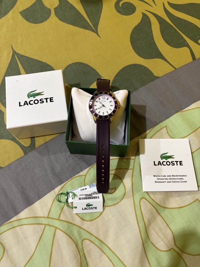 AUTHENTIC LACOSTE WATCH (Category: Women's Watches) located in Manila. Submitted by elizabeth-declutter (Listing ID 1460892186, Image 3). Description: Authentic Lacoste Watch (Complete Set) Brand / Item: Authentic Lacoste Watch (Gold Bezel, Dark Purple Strap) Condition: Brand New / Unused Inclusions: Complete with original box, watch pillow, manual/warranty guide, and price tag. Original Retail Price: $195.00 Selling Price: ₱ 9,999 Details: Comes