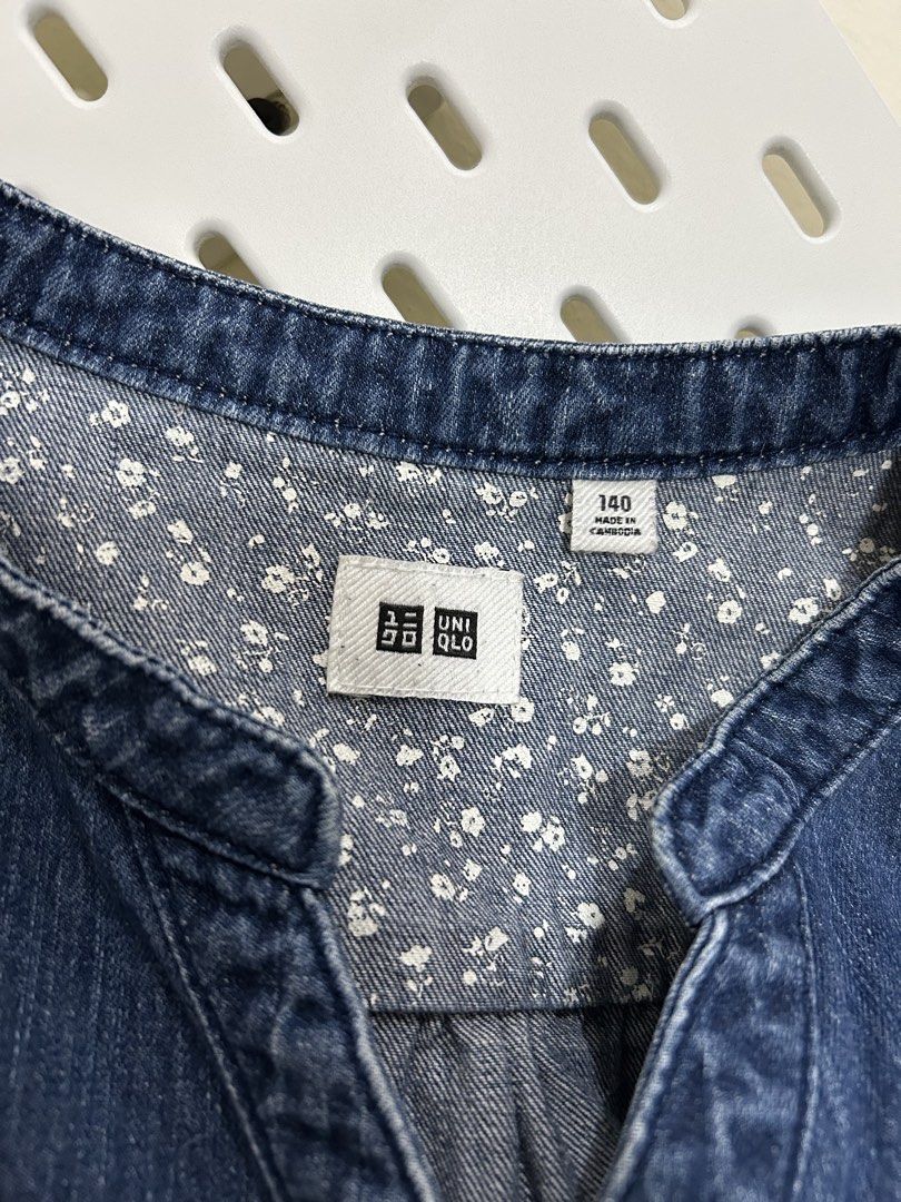Authentic Uniqlo Washed Denim Tunic (Category: Babies & Kids Fashion) located in Manila. Submitted by maison_marie (Listing ID 1460871817, Image 2). Description: Features a mandarin-style collar, button-front design, long sleeves, and two front chest pockets. Comes with a floral print detail on the upper back neckline and two side pockets. Size: 140 Length: 30 inches Location: Malate, Manila Available for pick-up or same-day delivery. For same-da
