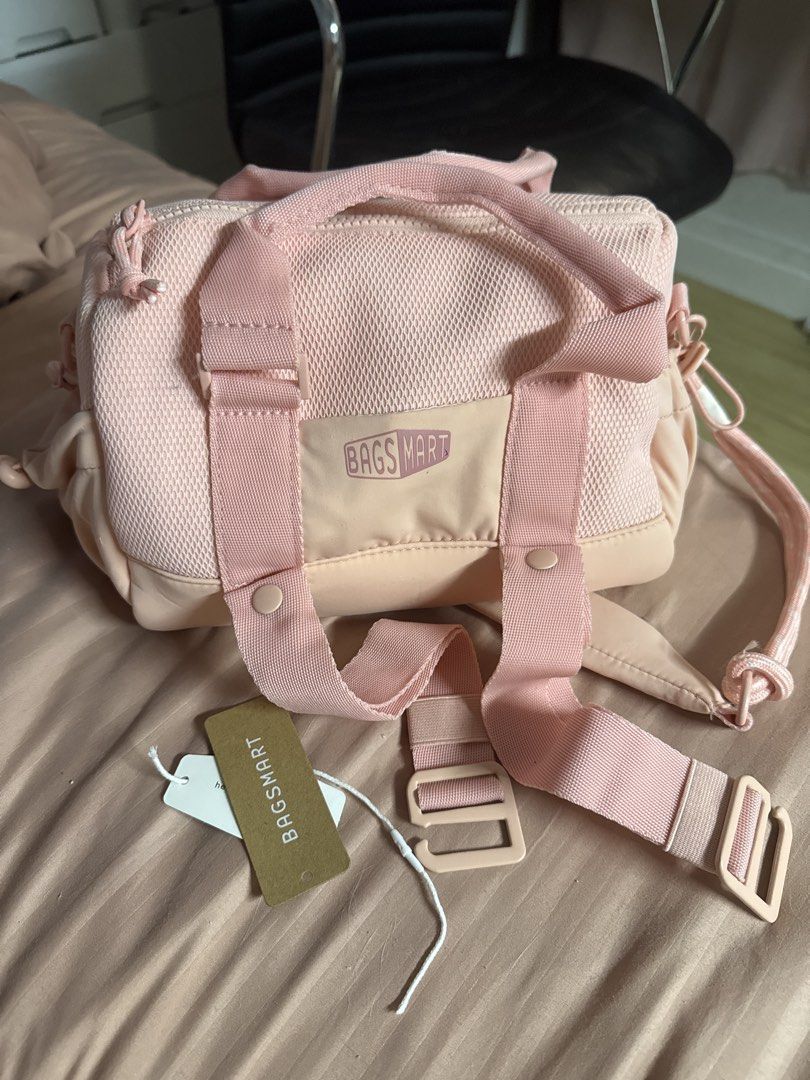 BAGSMART Pink Duffle Bag (Category: Shoulder Bags) located in Manila. Submitted by eancc (Listing ID 1460813255, Image 1). Description: Gift only, with tag, black keychain lanyard is not included, otherwise clean and no damages Rfs: hindi nagagamit GCASH BDO BPI Can do lalamove JNT Loc: Avida Towers San Lazaro, Santa Cruz, Manila - Cute pink duffle bag from BAGSMART - Features a mesh front panel - Adjustable straps for comfort - Brand new with ta