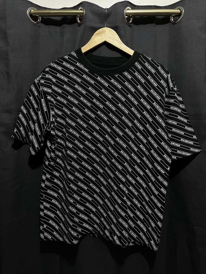 Balenciaga All-Over Diagonal Logo Print Boxy Tee (Category: Tshirts & Polo Shirts ) located in Buenavista. Submitted by themodernrack (Listing ID 1460874591, Image 1). Description: Brand: Balenciaga Color: Black / White Style: Oversized / Boxy Luxury Streetwear Tee (Features all-over diagonal Balenciaga repeating print) Tag Size: XXS (Fits boxy/oversized — check measurements) Condition: Pre-owned (Missing neck tag, minimal collar fade, general fa