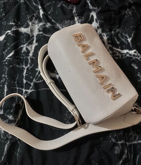 Balmain White Leather Crossbody Bag (Category: Luxury Bags & Wallets) located in Caloocan City. Submitted by live.staypretty_012 (Listing ID 1460904269, Image 2). Description: - Genuine white pebbled leather crossbody bag - Gold Balmain lettering - Unique cylindrical shape - Secure zipper closure - Interior zippered pocket for essentials - Adjustable strap for comfortable wear - Ideal for everyday use or travel -NO dents or scratches RFS : No lon