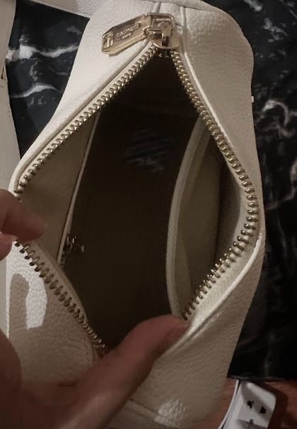 Balmain White Leather Crossbody Bag (Category: Luxury Bags & Wallets) located in Caloocan City. Submitted by live.staypretty_012 (Listing ID 1460904269, Image 3). Description: - Genuine white pebbled leather crossbody bag - Gold Balmain lettering - Unique cylindrical shape - Secure zipper closure - Interior zippered pocket for essentials - Adjustable strap for comfortable wear - Ideal for everyday use or travel -NO dents or scratches RFS : No lon