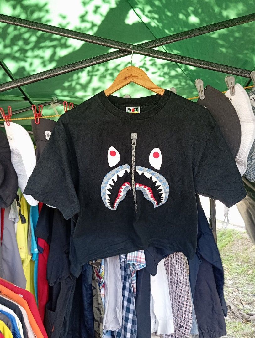 BAPE A Bathing Ape Shark Face Zip T-Shirt (Category: Tshirts & Polo Shirts ) located in Manila. Submitted by jzk25 (Listing ID 1460809747, Image 1). Description: - Authentic Black BAPE T-Shirt - Features the iconic Shark Face graphic - Unique zip detail on the shark's mouth - Tagged size L (fits comfortably) - Made from soft, breathable cotton - Ideal for everyday casual wear - A must-have statement piece for your streetwear collection!.