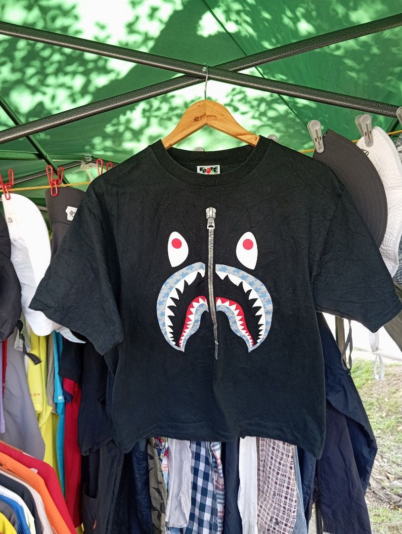 BAPE A Bathing Ape Shark Face Zip T-Shirt (Category: Tshirts & Polo Shirts ) located in Manila. Submitted by jzk25 (Listing ID 1460809747, Image 2). Description: - Authentic Black BAPE T-Shirt - Features the iconic Shark Face graphic - Unique zip detail on the shark's mouth - Tagged size L (fits comfortably) - Made from soft, breathable cotton - Ideal for everyday casual wear - A must-have statement piece for your streetwear collection!.