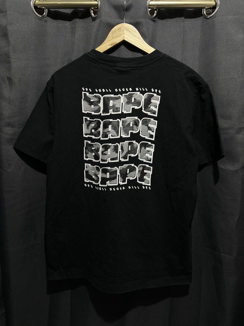 BAPE "Ape Shall Never Kill Ape" Block Camo Logo Tee (Category: Tshirts & Polo Shirts ) located in Buenavista. Submitted by themodernrack (Listing ID 1460894374, Image 2). Description: Brand: A Bathing Ape (BAPE) Color: Black Style: Short Sleeve Graphic Tee (Features front chest “BAPE” ape head text and large back-stacked BAPE block logo print in grey camo) Tag Size: Unmarked / Tag faded (Fits Medium, see measurements) Condition: Good used conditi