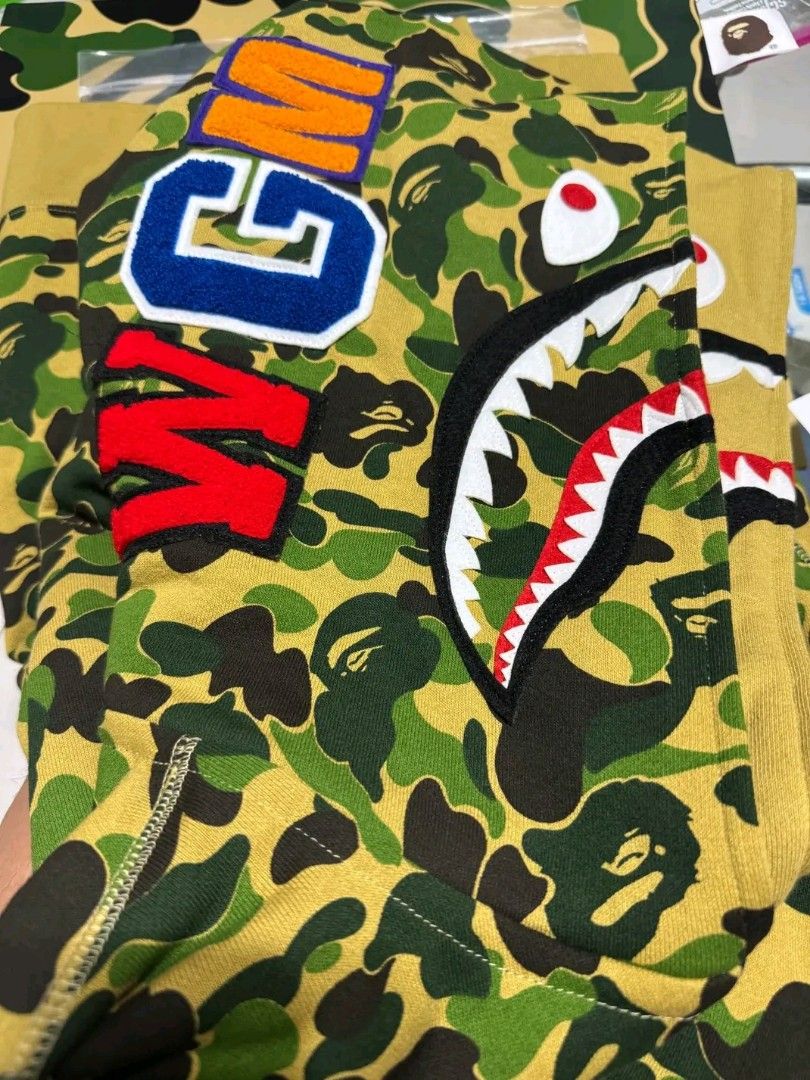 BAPE Double head shark Jacket (Category: Golf) located in Manila. Submitted by puretiger_a2ce98 (Listing ID 1460909036, Image 2). Description: Bape double headed shark Jacket Green Camouflage conditions never worn at All bought purely for Collection Purposes Purchase officially from Bape store.